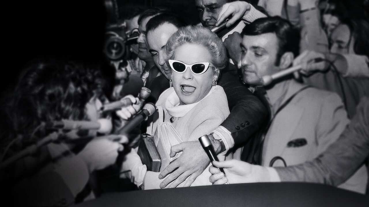 a woman surrounded by reporters